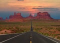 Scenic highway in Monument Valley Tribal Park in Arizona-Utah border, U.S.A. at sunset. Royalty Free Stock Photo