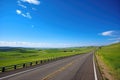 scenic highway with view of rolling hills, farmland, and blue skies Royalty Free Stock Photo