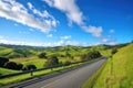 scenic highway with view of rolling hills, farmland, and blue skies Royalty Free Stock Photo