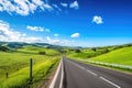 scenic highway with view of rolling hills, farmland, and blue skies Royalty Free Stock Photo