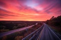 scenic highway with view of the sunrise, with pink and orange hues in the sky