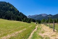 Bodental - Scenic hiking trail along lush green alpine meadow with scenic view of Karawanks mountains, Bodental