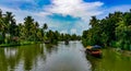 Scenic Houseboat on the backwaters during monsoon in Alleppey, Kerala, India.