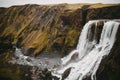 scenic icelandic landscape with majestic Fagrifoss waterfall and rocks