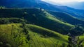 Scenic of idyllic rolling hills landscape with blooming meadows and mountain ranges in the background on a beautiful sunny day Royalty Free Stock Photo