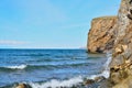 Scenic lake coast landscape rock waves. Blue sky and clear water. Royalty Free Stock Photo