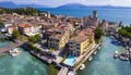 Scenic lake Lago di Garda aerial drone view of Sirmione town and medieval castle Scaligero. Italy, Royalty Free Stock Photo