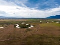 Scenic landscape aerial view of field river and basin against a natural mountain, Drone shot tropical landscape with noise and Royalty Free Stock Photo