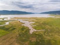 Scenic landscape aerial view of field river and basin against a natural mountain, Drone shot tropical landscape Royalty Free Stock Photo