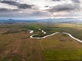 Scenic landscape aerial view of field river and basin against a natural mountain, Drone shot tropical landscape Royalty Free Stock Photo