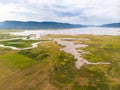 Scenic landscape aerial view of field river and basin against a natural mountain, Drone shot tropical landscape with noise and Royalty Free Stock Photo