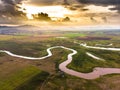 Scenic landscape aerial view of field river and basin against a natural mountain, Drone shot tropical landscape with noise and Royalty Free Stock Photo