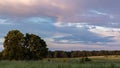 Scenic landscape background, sunset in Belarus over green meadow in summer, local travel, rainbow in the sky after the rain Royalty Free Stock Photo