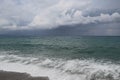 Scenic landscape on the beach and dark blue sea, storm clouds, sky during rain Royalty Free Stock Photo