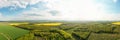 Scenic landscape of countryside from bird`s eye view, springtime. Aerial drone view of woodland and farmland