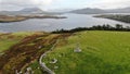 Scenic landscape with green fields and a sea shore during daytimen Royalty Free Stock Photo