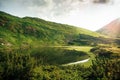 Scenic landscape on green mountains and lake in the Carpathians. Nesamovyte lake in summer Royalty Free Stock Photo