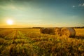 Scenic Landscape With Group Of Straw Bales On Agricultural Field At Sunrise Royalty Free Stock Photo
