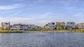 Scenic landscape with lakefront homes against sky