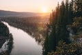 Scenic landscape, man on on edge of cliff meeting beutiful sunrise over mountain river Usva, Russia, Ural mountains