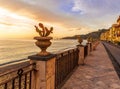 scenic landscape of morning sunrise embarkment with road and sidewalk, fence with decorations of cactuses Royalty Free Stock Photo