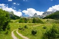 Scenic landscape of mountain valley in european Alps. Road goes into the distance. Stunning view of mountains and valleys in Royalty Free Stock Photo