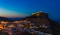 Scenic landscape photo of night Lindos town and castle on Rhodes island, Dodecanese, Greece. Panorama with bright lights, Royalty Free Stock Photo