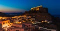 Scenic landscape photo of night Lindos town and castle on Rhodes island, Dodecanese, Greece. Panorama with bright lights, Royalty Free Stock Photo