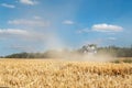 Scenic landscape of ripe golden organic wheat stalk field against blue sky on bright sunny summer day. Cereal crop Royalty Free Stock Photo