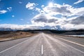 A scenic landscape of road to Aoraki Mount Cook - Lake Pukaki with blue sky and clouds. Royalty Free Stock Photo