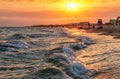 Scenic landscape of sandy Blaga Beach at stormy Black Sea coast with surfing waves breaking on seashore. Summer sunset scenery