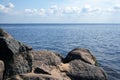 Scenic landscape with sandy shore, boulders, sea and sky Royalty Free Stock Photo