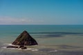 Scenic landscape of small island in the middle of the blue ocean with a clear sky