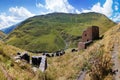 Scenic landscape of summer morning in the Caucasus mountains. Sun just came out and illuminates ancient ruins of Tushetian towers Royalty Free Stock Photo