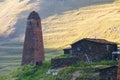 Scenic landscape of summer morning in the Caucasus mountains. Sun just came out and illuminates ancient ruins of Tushetian towers Royalty Free Stock Photo