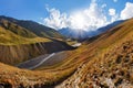 Scenic landscape of summer morning in the Caucasus mountains. Sun just came out and illuminates landscape. Trekking from Omalo. Royalty Free Stock Photo