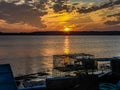 Setting Sun in a Cloudscape with Lobster Traps Royalty Free Stock Photo