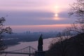 Scenic landscape view of Dnipro River with the Pedestrian Bridge and famous Monument of Vladimir The Great during surise