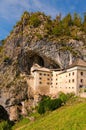 Scenic landscape view of famous Predjama castle at sunny autumn day. Famous touristic place and travel destination in Europe.