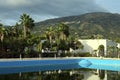 Scenic landscape view of large swimming pool and palm trees in the background. Marina di Patti Royalty Free Stock Photo