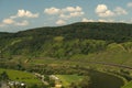 Scenic landscape of vineyards alongside the river Moselle near Puenderich, Germany on a sunny day