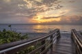 Bridge to the Clouded Sunrise over the Ocean Royalty Free Stock Photo