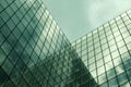 Scenic low angle shot of a facade of a modern glass building under cloudy sky - great for wallpapers Royalty Free Stock Photo