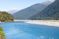 Scenic Makarora River flowing between bush-clad mountains of Southern Alps