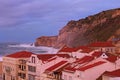 Scenic morning landscape view of storm in Atlantic ocean near Nazare. Big wave breaks about picturesque cliff. Nazare, Portugal. Royalty Free Stock Photo