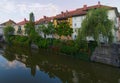 Scenic morning view of city center of Ljubljana. Ancient colorful buildings reflected in water of Ljubljanica River. Royalty Free Stock Photo