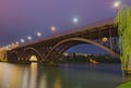 Scenic morning view of illuminated Old Bridge also named the State over Drava River. Selective focus with wide angle lens. Royalty Free Stock Photo