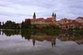 Scenic morning view of medieval Telc at sunrise. Buildings are reflected in the water