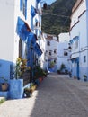 Scenic moroccan street in Chefchaouen city in Morocco - vertical