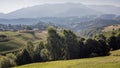 Scenic mountain landscape. Beautiful summer mountain landscape with green field and dramatic cloudy sky in Romanian Carpathian